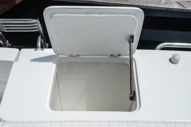Slide: The Image of Open hatch on 2011 Skipjack 300 Flybridge boat deck, showing storage compartment. - 35