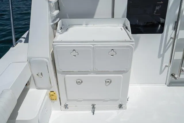 Slide: The Image of Skipjack 300 Flybridge 2011 boat deck with storage compartments and clean white finish. - 37