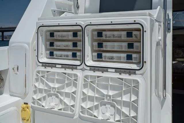 Slide: The Image of Tackle storage on 2011 Skipjack 300 Flybridge boat, featuring organized fishing gear compartments. - 38