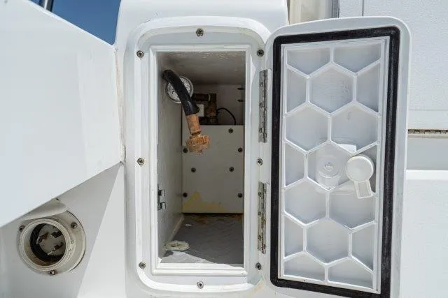 Slide: The Image of Open compartment on 2011 Skipjack 300 Flybridge boat, showing interior components. - 40