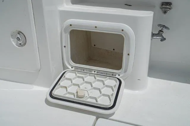Slide: The Image of Open storage compartment on 2011 Skipjack 300 Flybridge boat. - 44