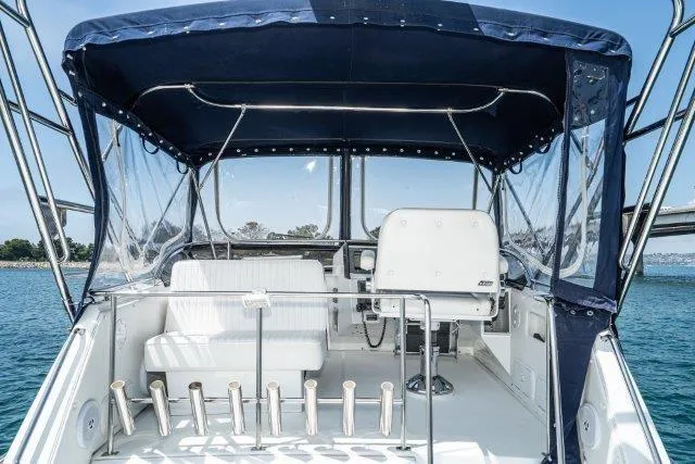 Slide: The Image of Flybridge view of 2011 Skipjack 300, featuring seating and ocean backdrop. - 48
