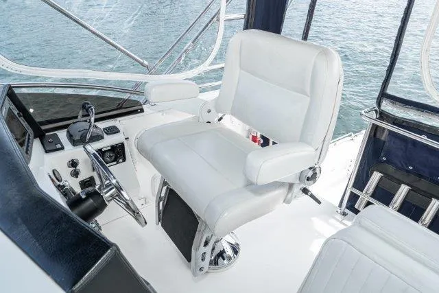 Slide: The Image of Captain's chair on 2011 Skipjack 300 Flybridge boat, overlooking water. - 49