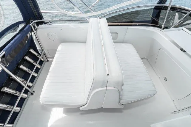 Slide: The Image of Flybridge seating on 2011 Skipjack 300, featuring white cushioned benches and sleek design. - 54