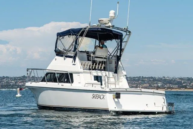 Slide: The Image of 2011 Skipjack 300 Flybridge boat cruising on a sunny day, featuring a sleek design. - 6