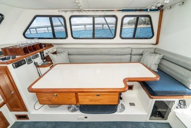 Slide: The Image of Interior of 2011 Skipjack 300 Flybridge with dining area and ocean view windows. - 65