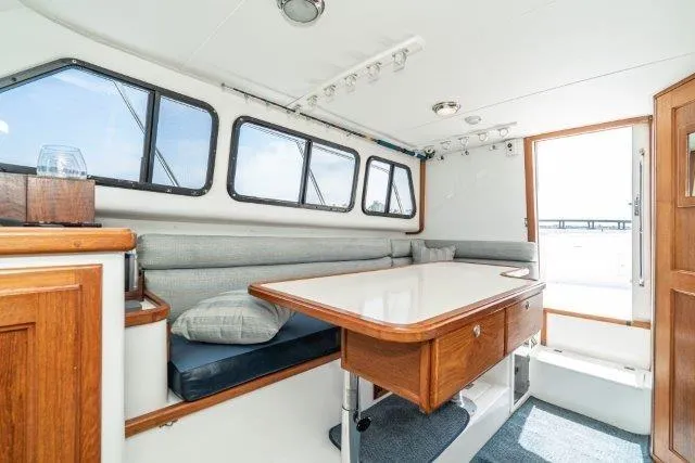 Slide: The Image of Interior of 2011 Skipjack 300 Flybridge boat with dining area and windows. - 66