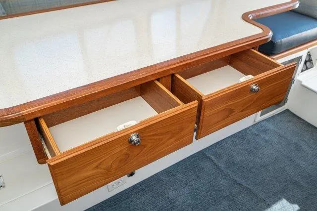 Slide: The Image of Open wooden drawers on a Skipjack 300 Flybridge 2011 boat interior. - 67