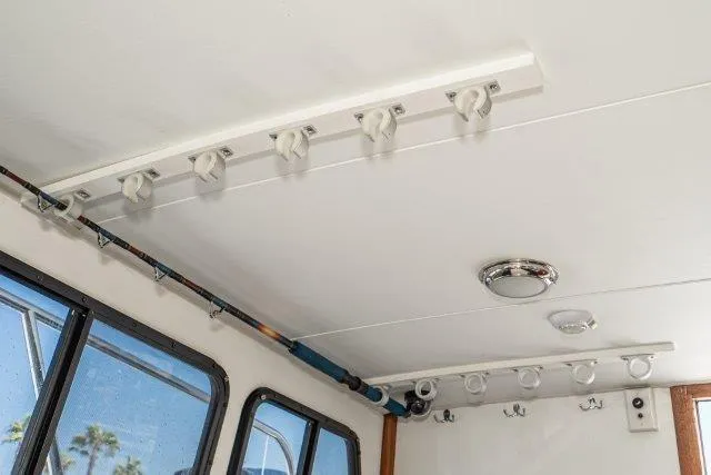 Slide: The Image of Ceiling view of 2011 Skipjack 300 Flybridge with rod holders and lighting fixtures. - 68