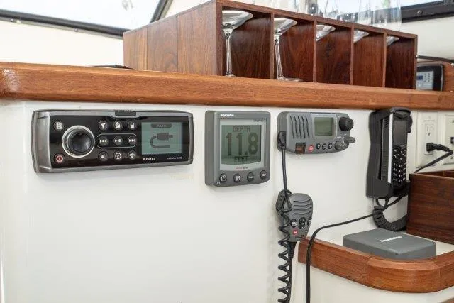 Slide: The Image of Control panel of a 2011 Skipjack 300 Flybridge with navigation and communication equipment. - 71