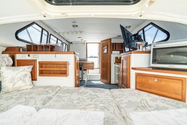 Slide: The Image of Interior of 2011 Skipjack 300 Flybridge boat with cozy cabin and modern amenities. - 74