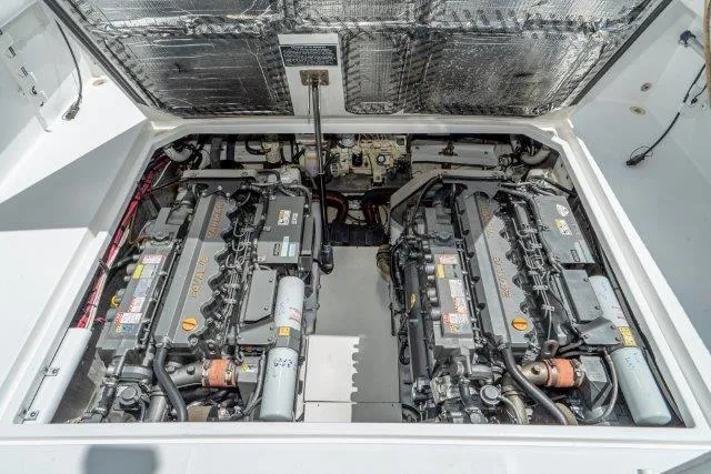 Slide: The Image of Engine compartment of a 2011 Skipjack 300 Flybridge boat, showcasing dual engines. - 79