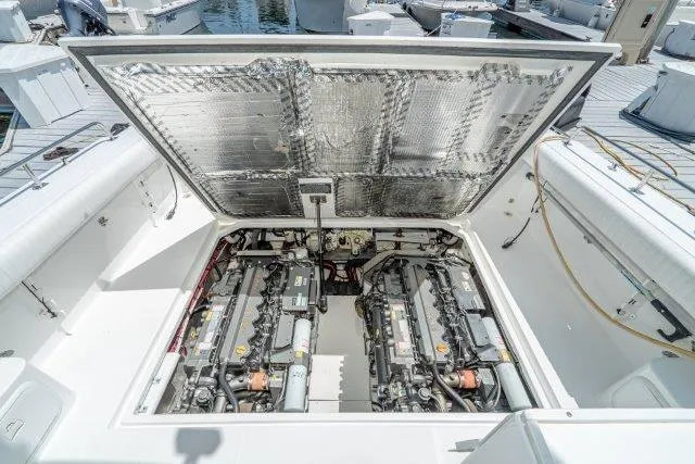 Slide: The Image of Engine compartment of 2011 Skipjack 300 Flybridge boat, showcasing dual engines and detailed components. - 82