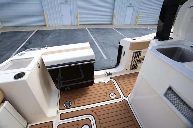 Slide: The Image of 2022 Scout 330 LXF boat interior with teak flooring and modern amenities. - 10