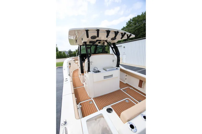 Slide: The Image of 2022 Scout 330 LXF boat interior with teak flooring and modern helm station. - 11