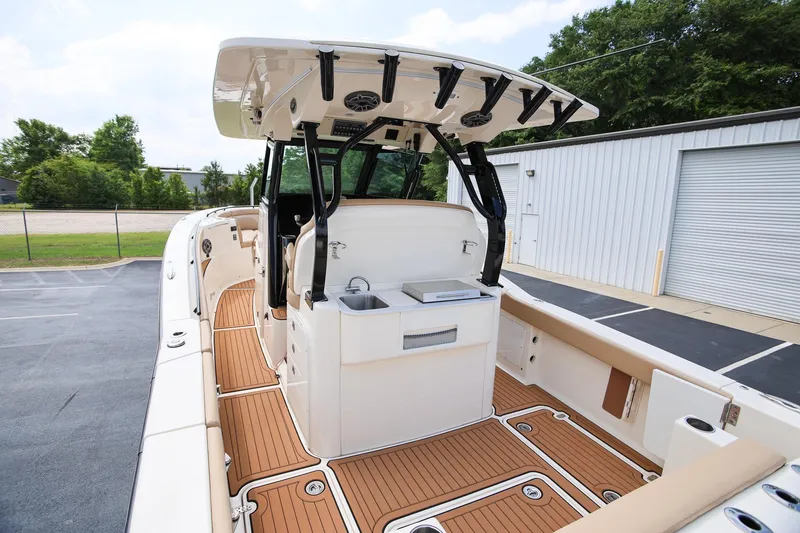 Slide: The Image of 2022 Scout 330 LXF boat interior with teak flooring and modern amenities. - 12