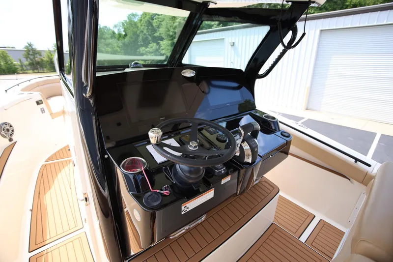Slide: The Image of 2022 Scout 330 LXF boat helm with modern controls and sleek design. - 14