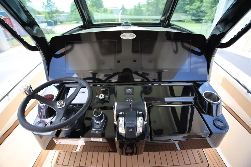 Slide: The Image of 2022 Scout 330 LXF boat dashboard with steering wheel and modern controls. - 15