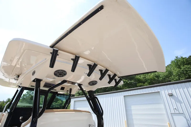 Slide: The Image of 2022 Scout 330 LXF boat with rod holders and speakers, viewed from below. - 17