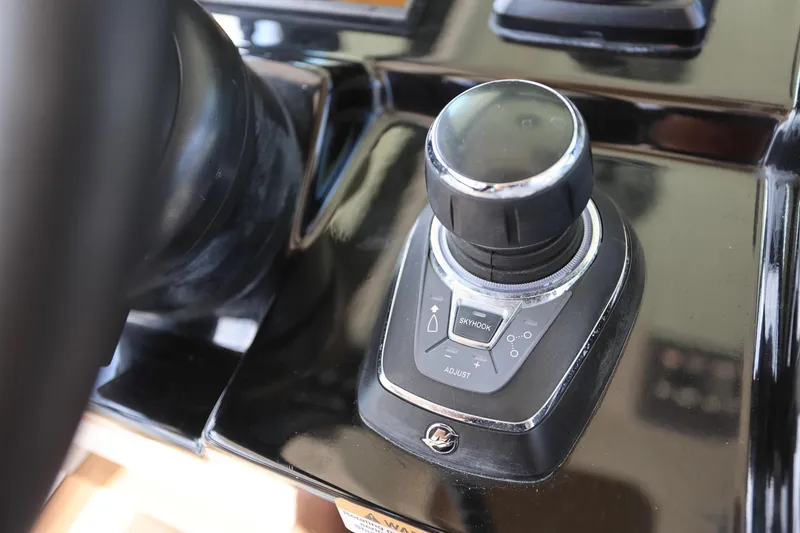 Slide: The Image of Close-up of 2022 Scout 330 LXF boat control panel with joystick and Skyhook feature. - 20