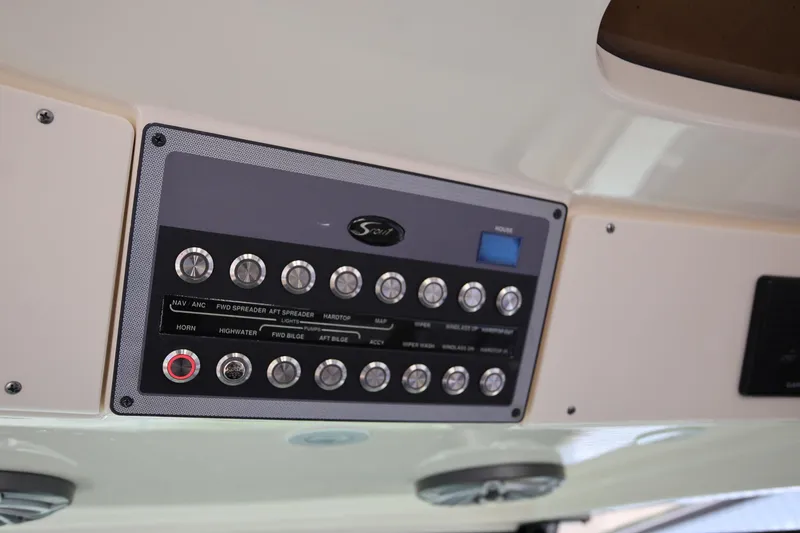 Slide: The Image of Control panel of a 2022 Scout 330 LXF boat with labeled switches and buttons. - 24