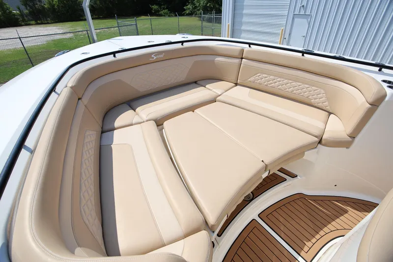 Slide: The Image of Luxurious seating area on 2022 Scout 330 LXF boat with tan upholstery and wood accents. - 25