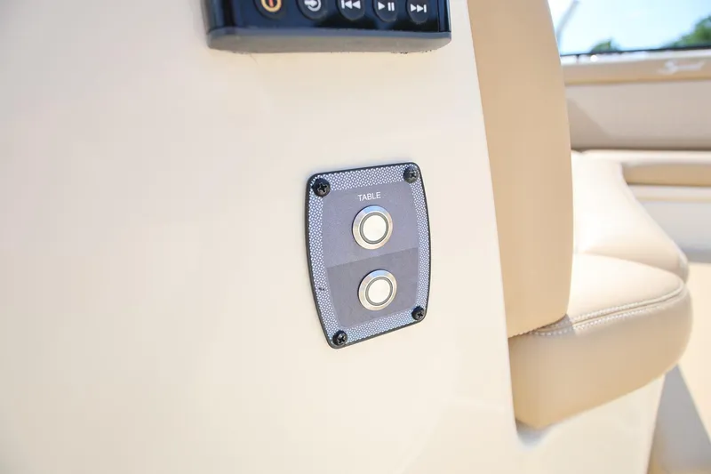 Slide: The Image of Control panel on 2022 Scout 330 LXF boat interior, featuring table adjustment buttons. - 26
