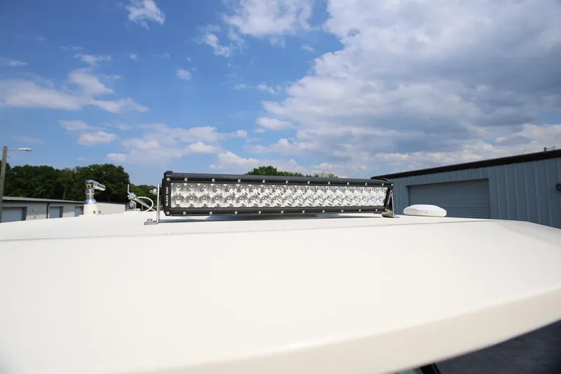 Slide: The Image of LED light bar on 2022 Scout 330 LXF boat under a partly cloudy sky. - 28