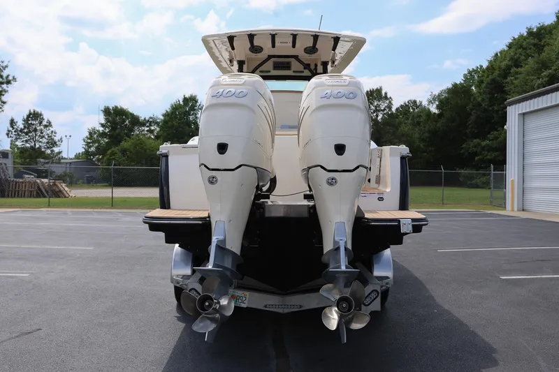 Slide: The Image of 2022 Scout 330 LXF boat with twin 400 horsepower engines, parked outdoors. - 3