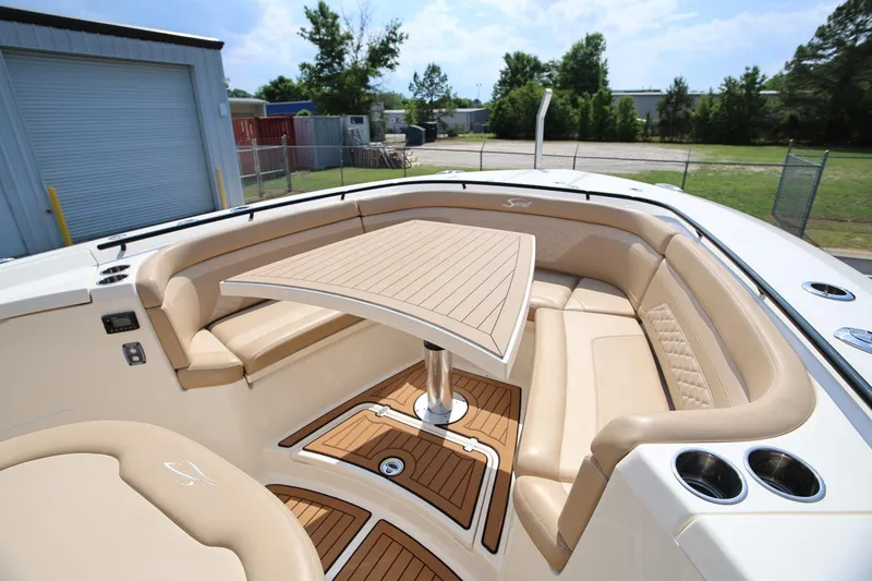 Slide: The Image of Luxurious seating area on 2022 Scout 330 LXF boat with elegant table and cup holders. - 30