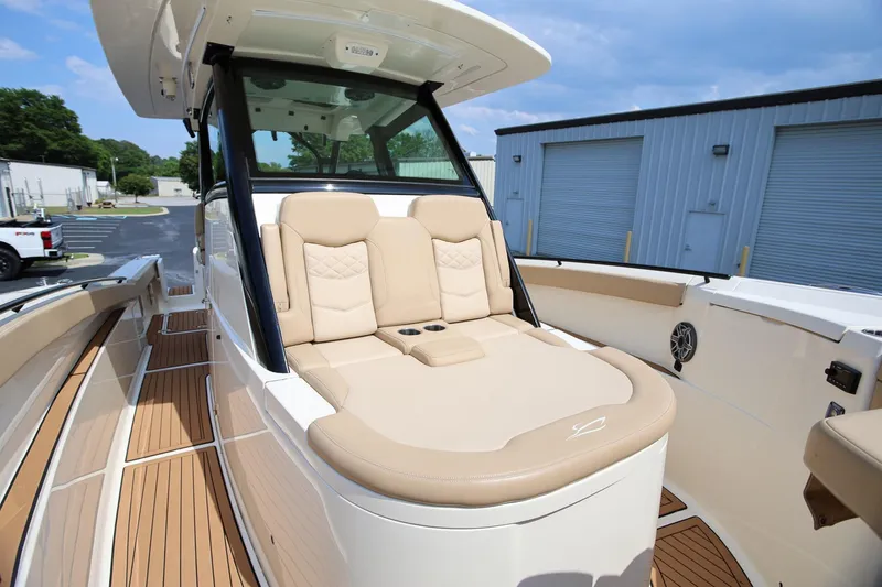 Slide: The Image of 2022 Scout 330 LXF boat with luxurious beige seating and sleek design. - 32