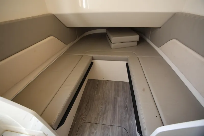 Slide: The Image of 2022 Scout 330 LXF cabin interior with beige seating and wood flooring. - 35