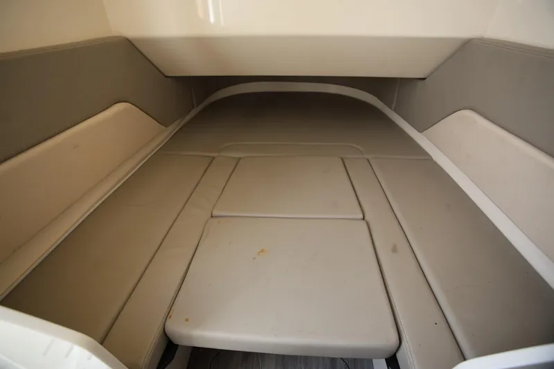 Slide: The Image of 2022 Scout 330 LXF cabin interior with beige cushioned seating. - 36