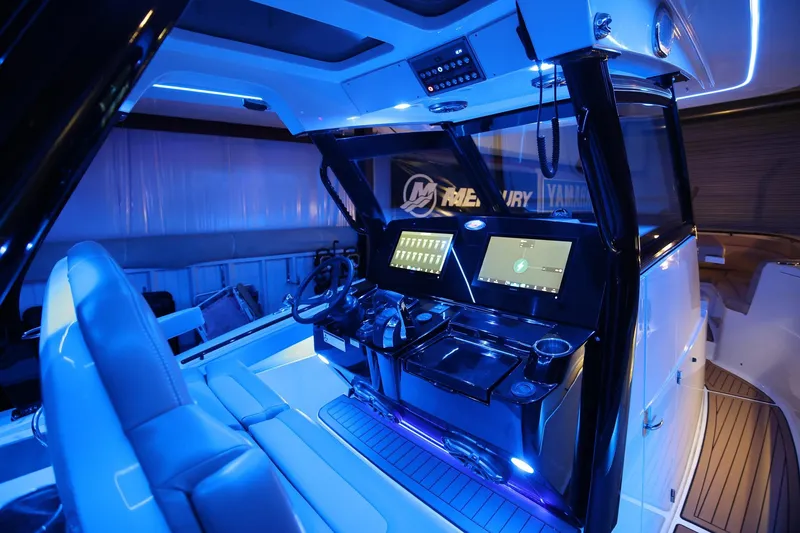 Slide: The Image of 2022 Scout 330 LXF boat interior with illuminated dashboard and modern controls. - 39