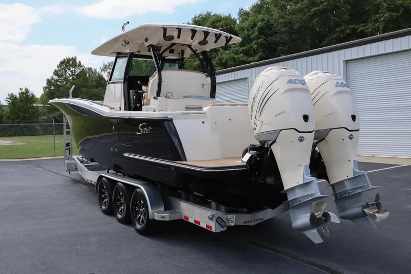Slide: The Image of 2022 Scout 330 LXF boat with dual 400 horsepower engines on a trailer. - 4