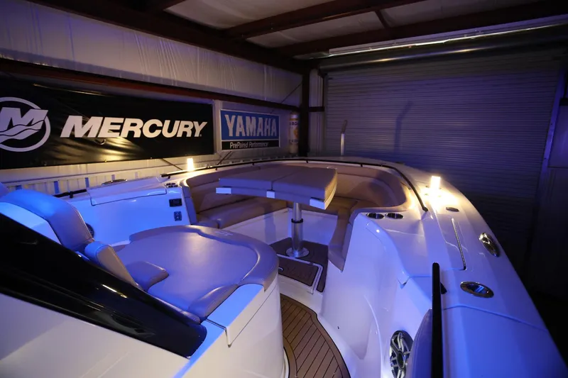 Slide: The Image of 2022 Scout 330 LXF boat interior with seating, illuminated in a showroom. - 40
