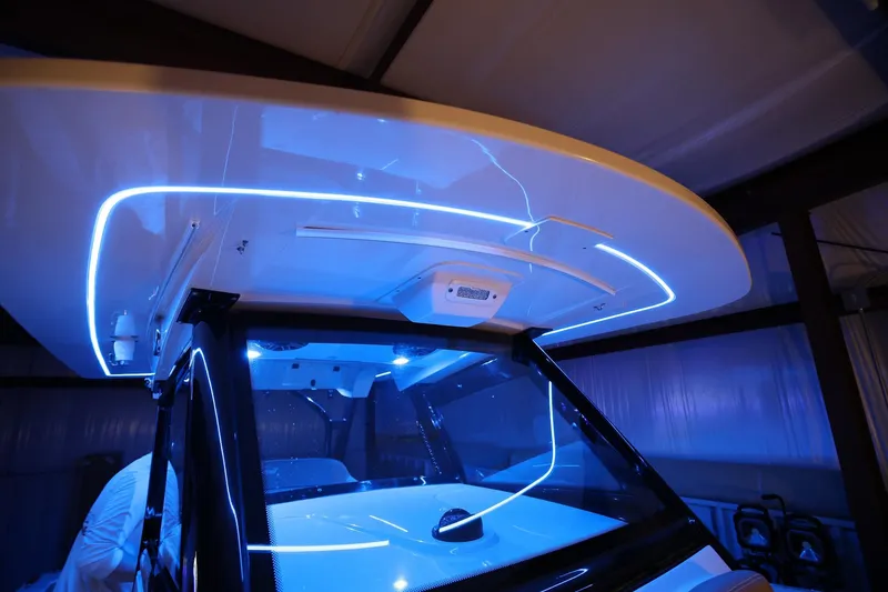 Slide: The Image of 2022 Scout 330 LXF boat with illuminated blue LED lighting under the hardtop. - 41