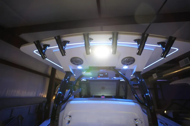 Slide: The Image of 2022 Scout 330 LXF boat interior with illuminated rod holders and speakers. - 45