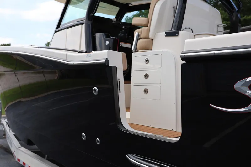 Slide: The Image of 2022 Scout 330 LXF boat with open side door and luxurious interior. - 7