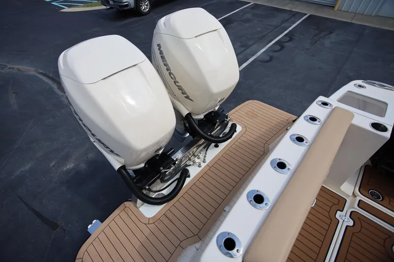 Slide: The Image of 2022 Scout 330 LXF boat with dual Mercury outboard engines on teak deck. - 8