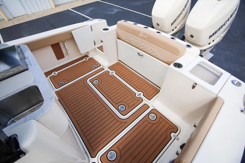 Slide: The Image of 2022 Scout 330 LXF boat interior with teak flooring and dual Mercury engines. - 9