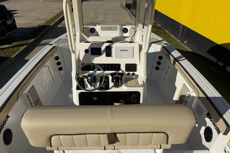 Slide: The Image of Interior view of 2026 Yamaha Boats 222 FSH Sport E, featuring helm and seating area. - 13