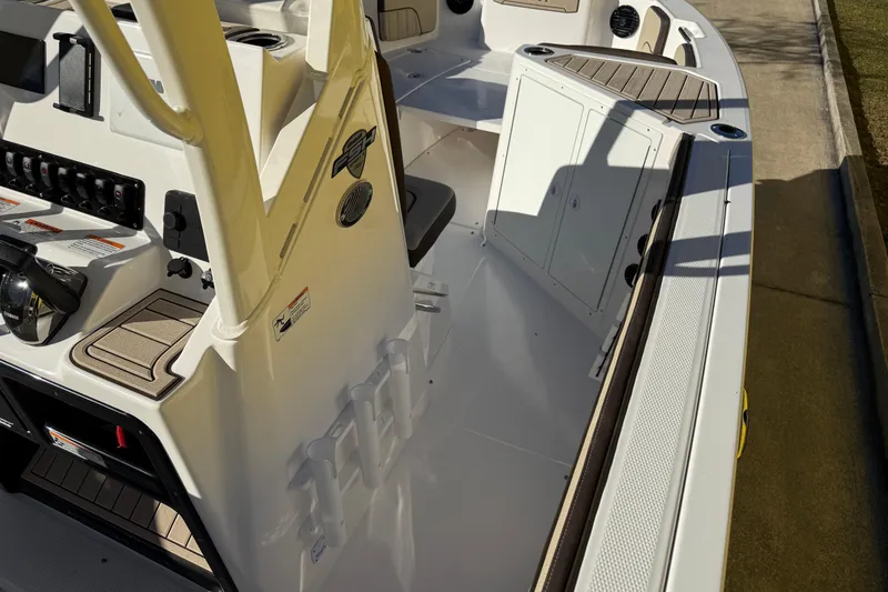 Slide: The Image of 2026 Yamaha Boats 222 FSH Sport E interior, showcasing helm controls and seating area. - 17