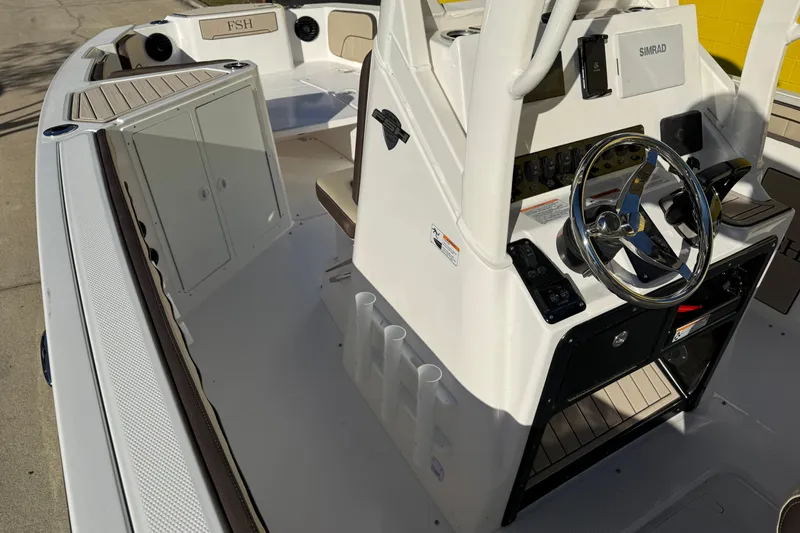Slide: The Image of 2026 Yamaha Boats 222 FSH Sport E interior with steering wheel and control panel. - 18