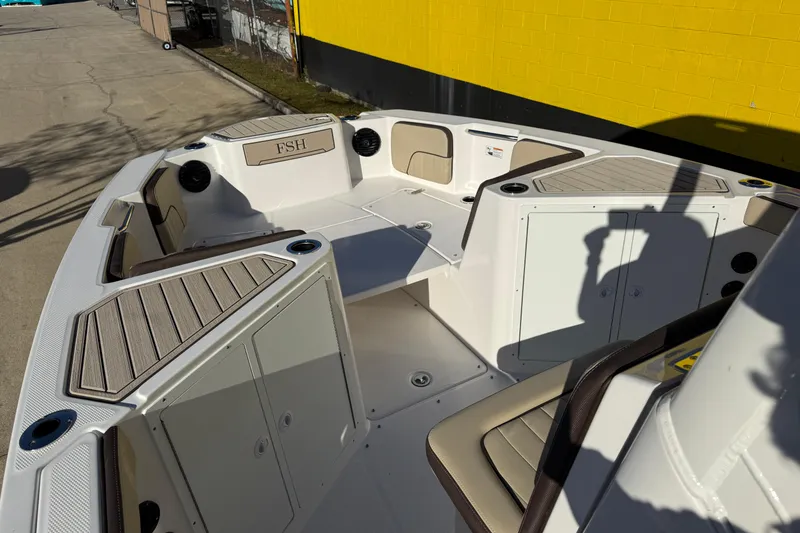 Slide: The Image of 2026 Yamaha Boats 222 FSH Sport E interior with seating and storage compartments. - 19
