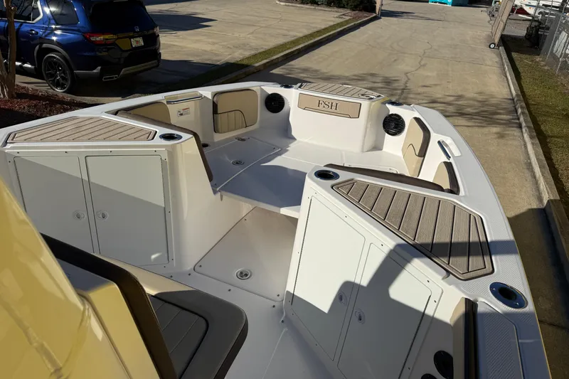 Slide: The Image of 2026 Yamaha Boats 222 FSH Sport E interior with seating and storage compartments. - 21