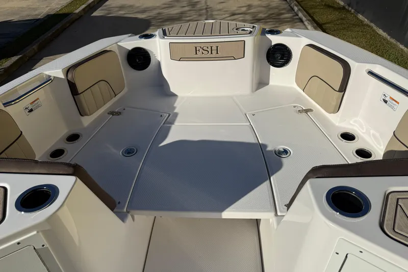 Slide: The Image of 2026 Yamaha Boats 222 FSH Sport E interior with seating and cup holders. - 22