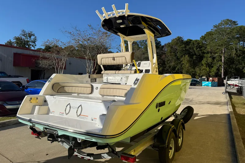 Slide: The Image of 2026 Yamaha Boats 222 FSH Sport E on trailer, parked outdoors, showcasing sleek design. - 9