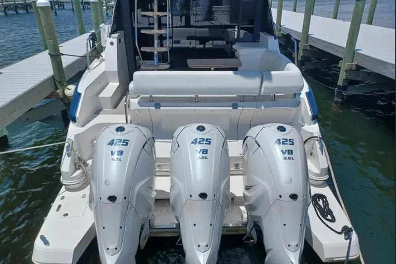Slide: The Image of 2023 Regal 42 FXO boat with triple 425 V8 engines docked at marina. - 4