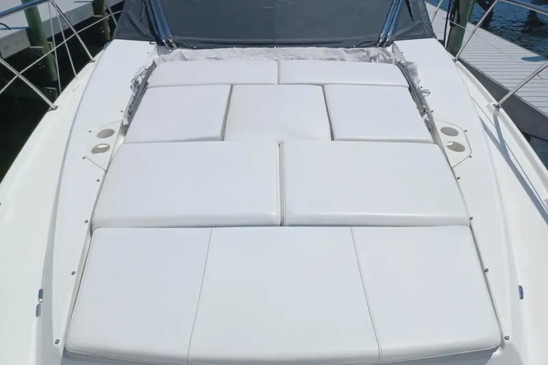 Slide: The Image of Sunpad on 2023 Regal 42 FXO yacht, featuring white cushioned seating. - 9